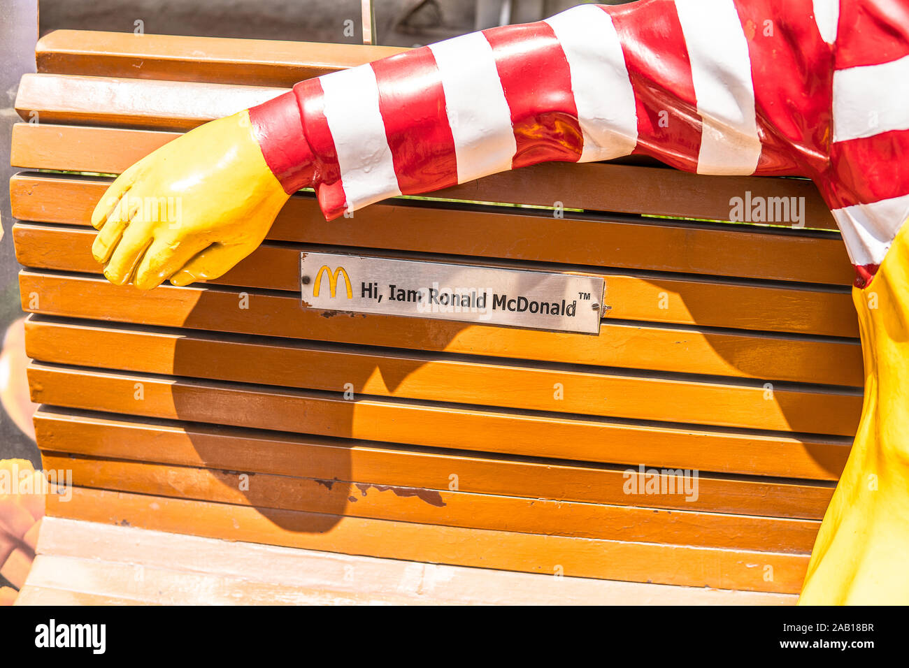 India, Bengaluru city, Ronald McDonald bench, greetings to all restaurant customers, mascot for children, yellow M symbol of McDonald restaurant Stock Photo