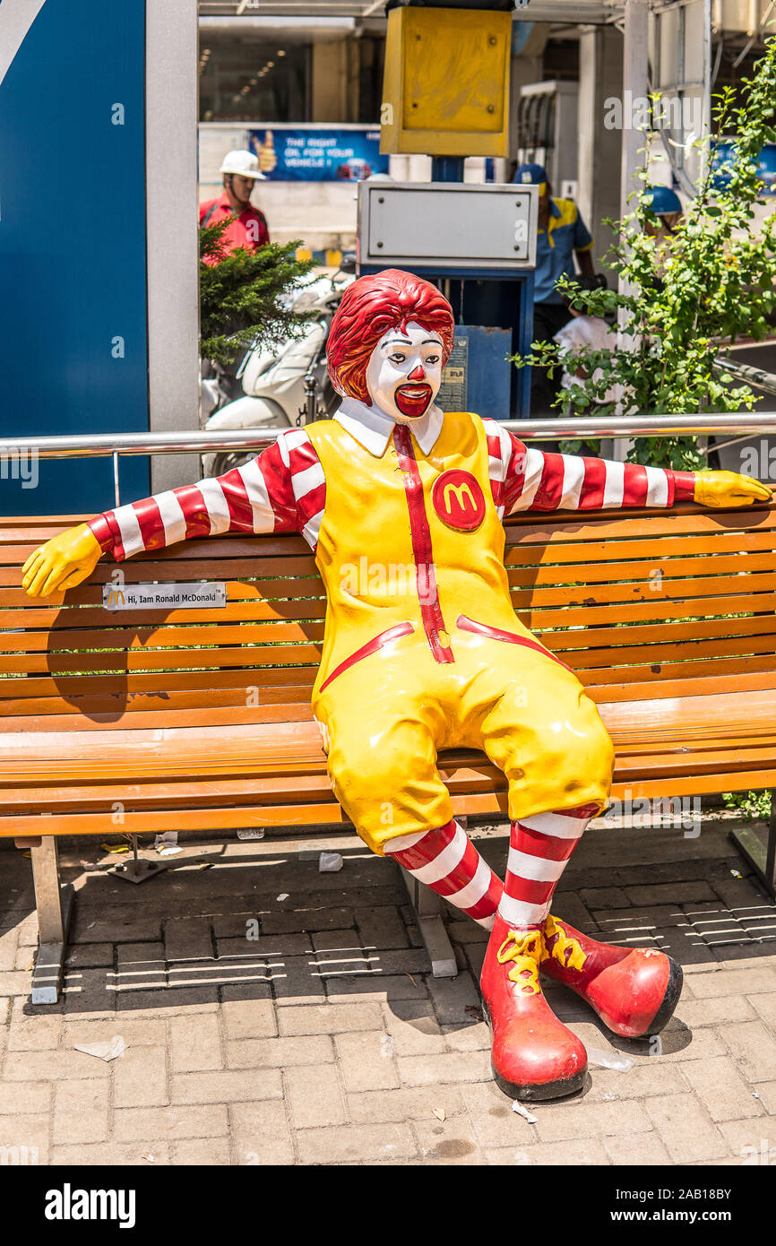 India, Bengaluru city, Ronald McDonald bench, greetings to all restaurant customers, mascot for children, yellow M symbol of McDonald restaurant Stock Photo