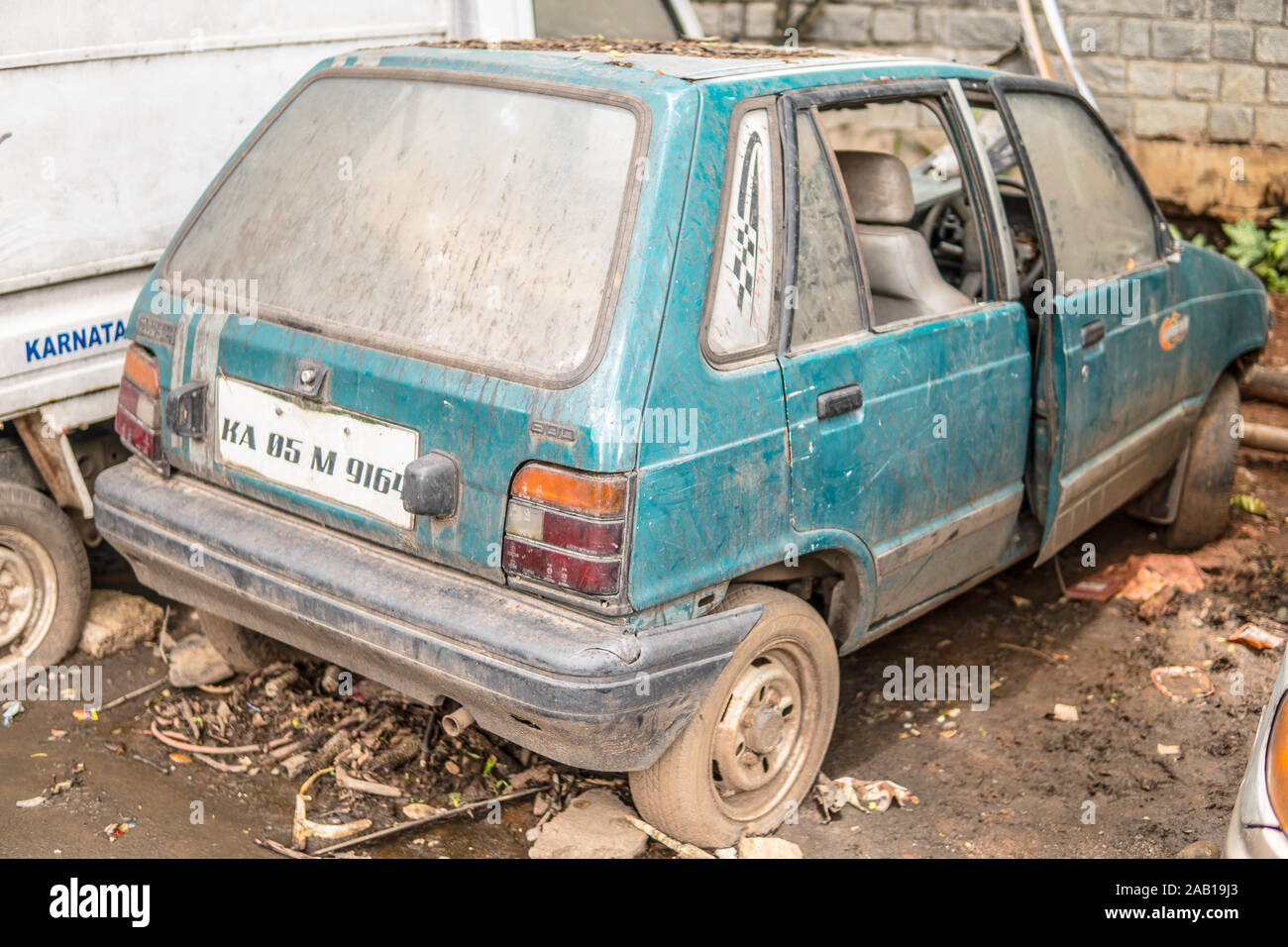 Bangalore, India, June 2018, streets of Bengaluru city, old destroyed and abandoned cars, dusty, muddy, incomplete Stock Photo