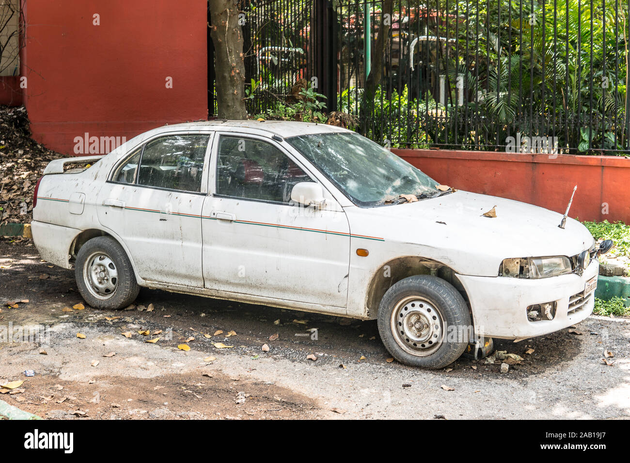 Bangalore, India, June 2018, streets of Bengaluru city, old destroyed and abandoned cars, dusty, muddy, incomplete Stock Photo