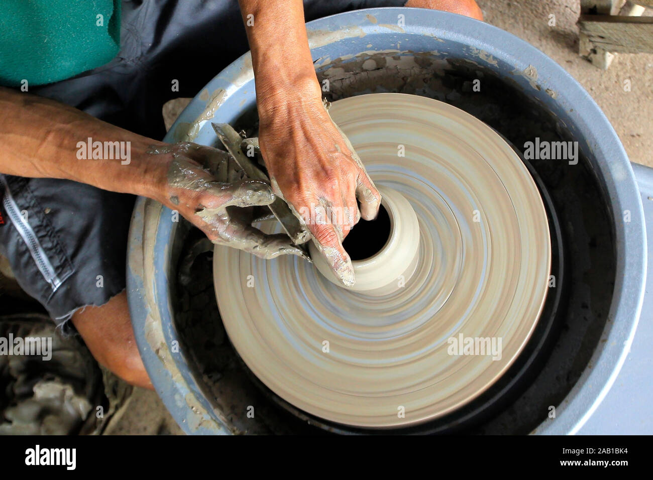 closeup of hands making pottery on pottery wheel Stock Photo