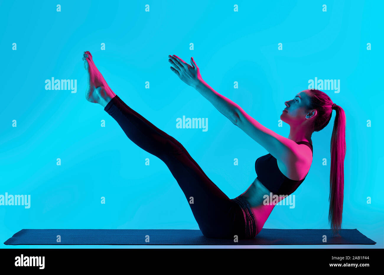 one caucasian woman exercising Navasana boat pose yoga exercices in ...