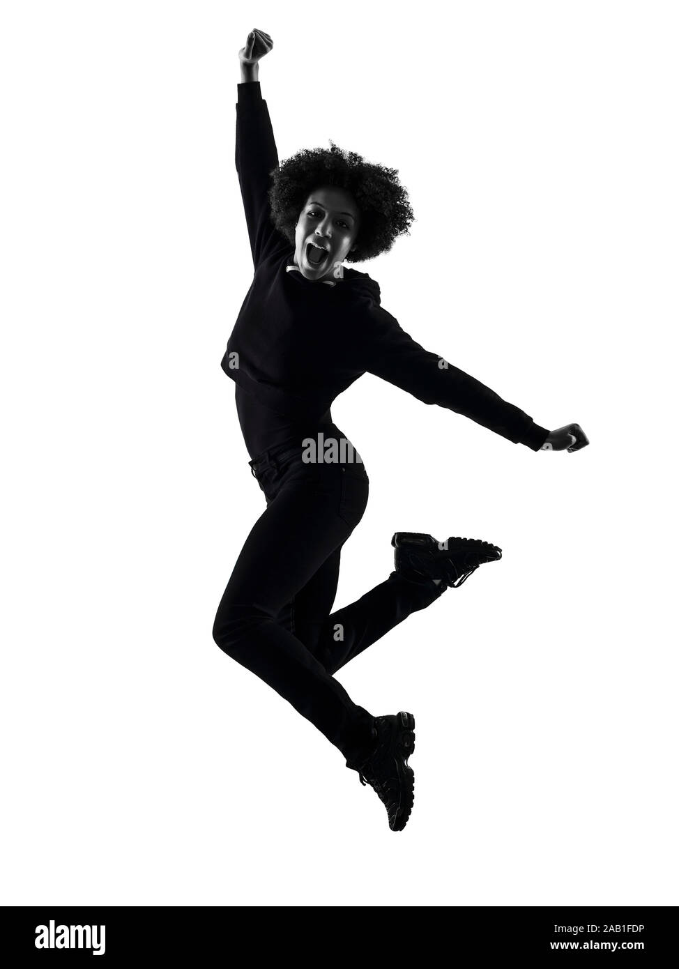one mixed race african young teenager girl woman jumping happy in studio shadow silhouette isolated on white background Stock Photo