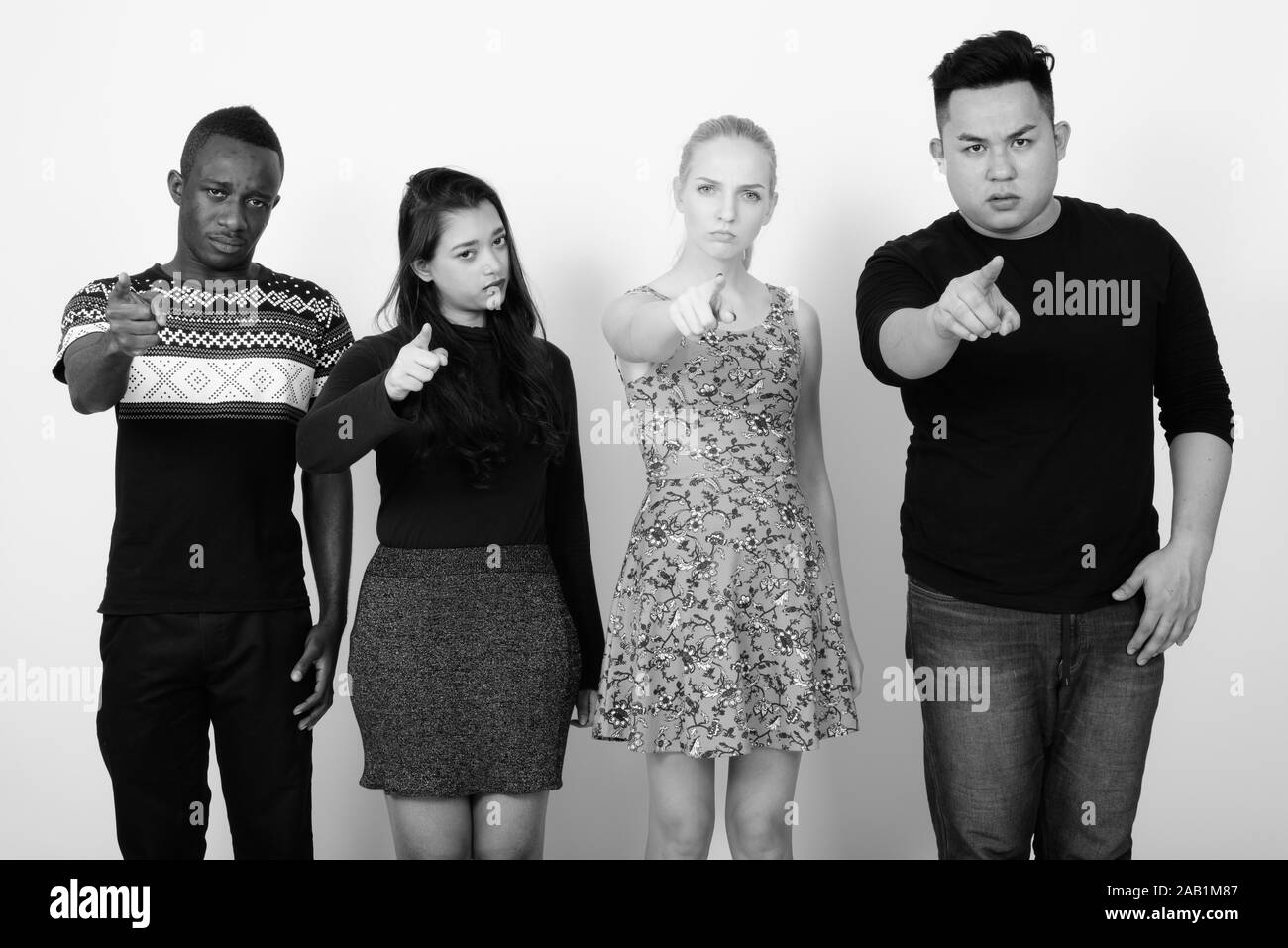 Studio shot of diverse group of multi ethnic friends looking angry while pointing at camera together Stock Photo