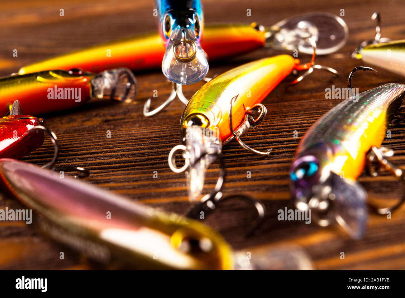 Fishing tackle background. Fishing tackles and wobbler on wooden board. Fishing  hooks, lures and baits. Fishing gear on a dark table Stock Photo - Alamy