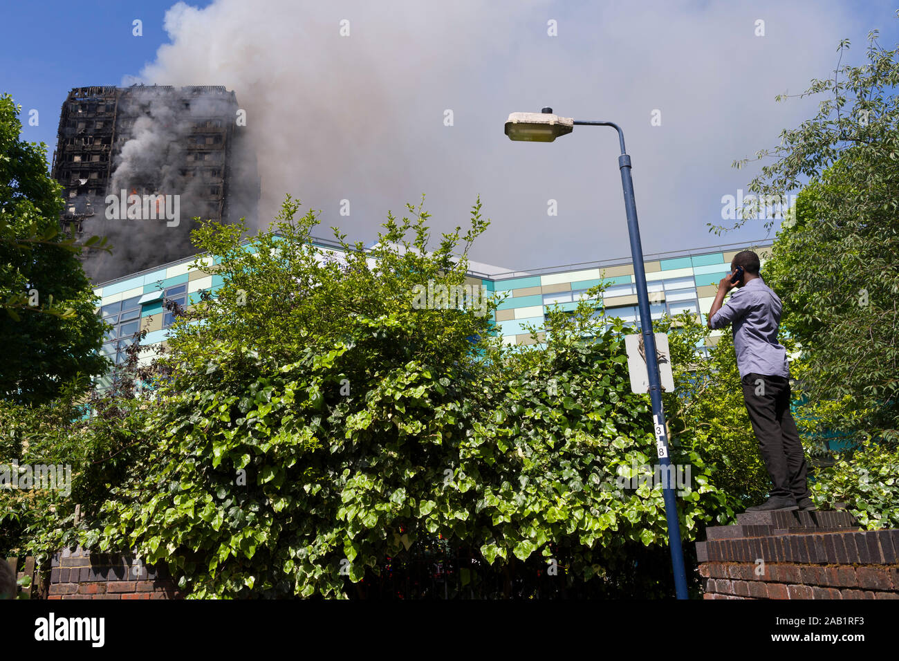 Onlooker watching the Grenfell Tower fire. Grenfell Tower was a 24