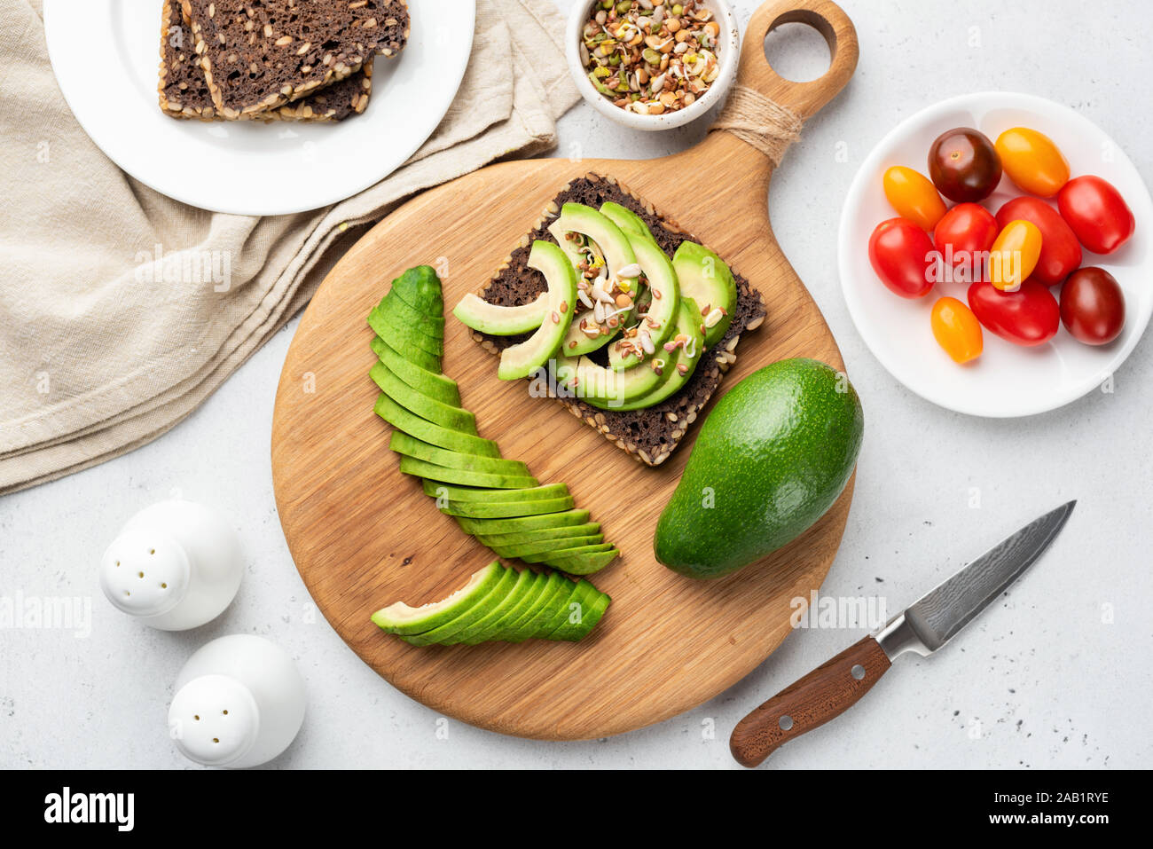 Healthy Toast With Avocado Rye Bread And Sprouts On Wooden Board. Top View. Clean Eating, Dieting, Weight Loss Food Concept Stock Photo