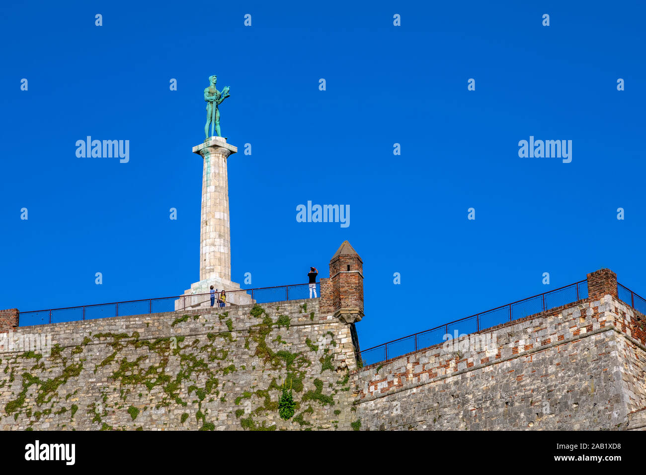 Tourists at the Belgrade fortress photograph the Victor monument. Image Stock Photo