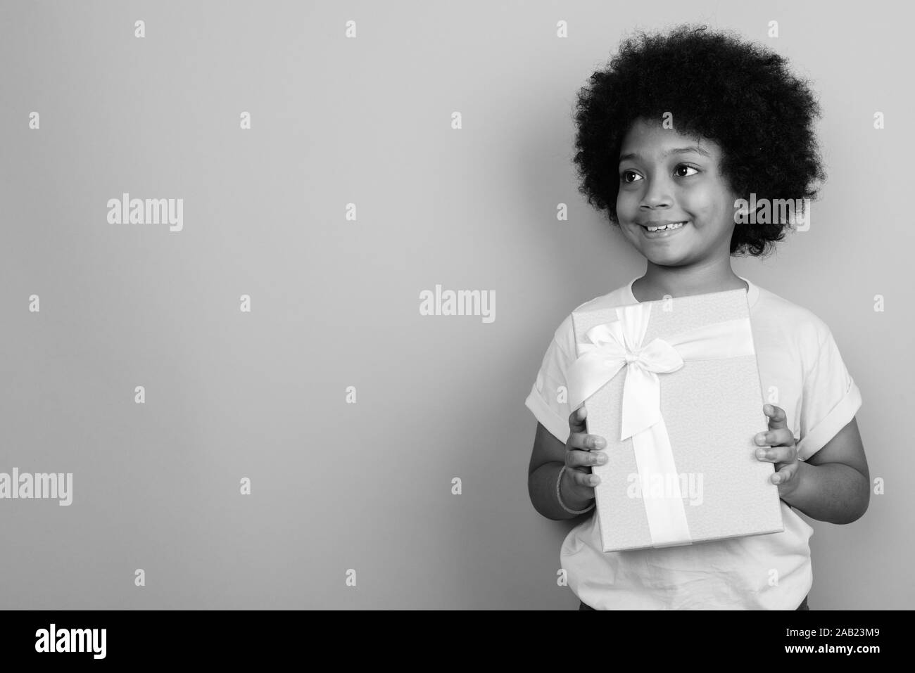 Young Cute African Girl With Afro Hair In Black And White Stock