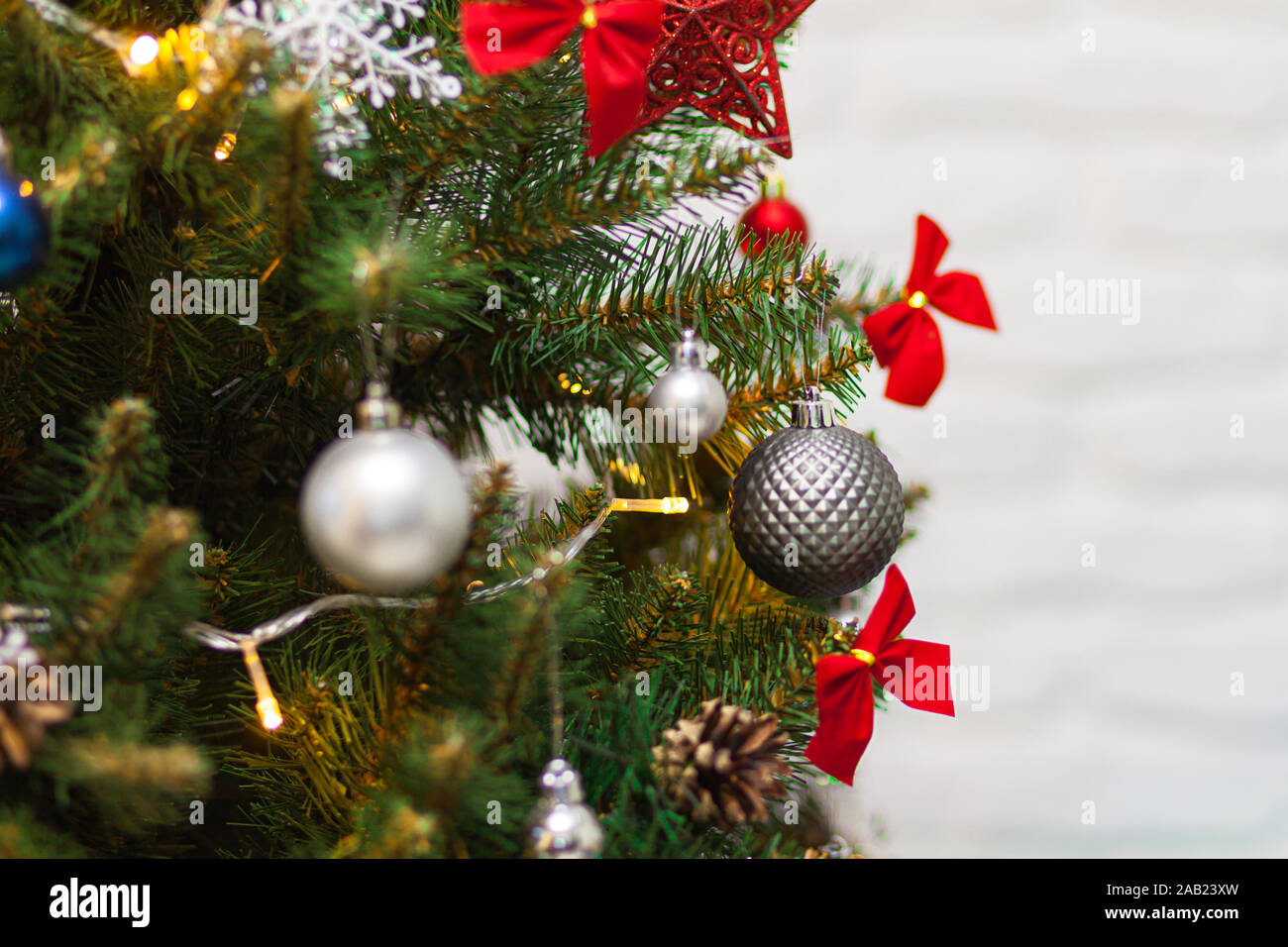 Beautiful green Christmas tree decorated with gray balls and garlands ...
