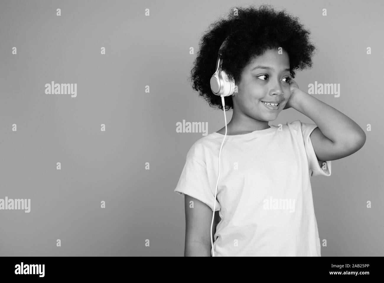 Girl smiling and listening to music Black and White Stock Photos ...