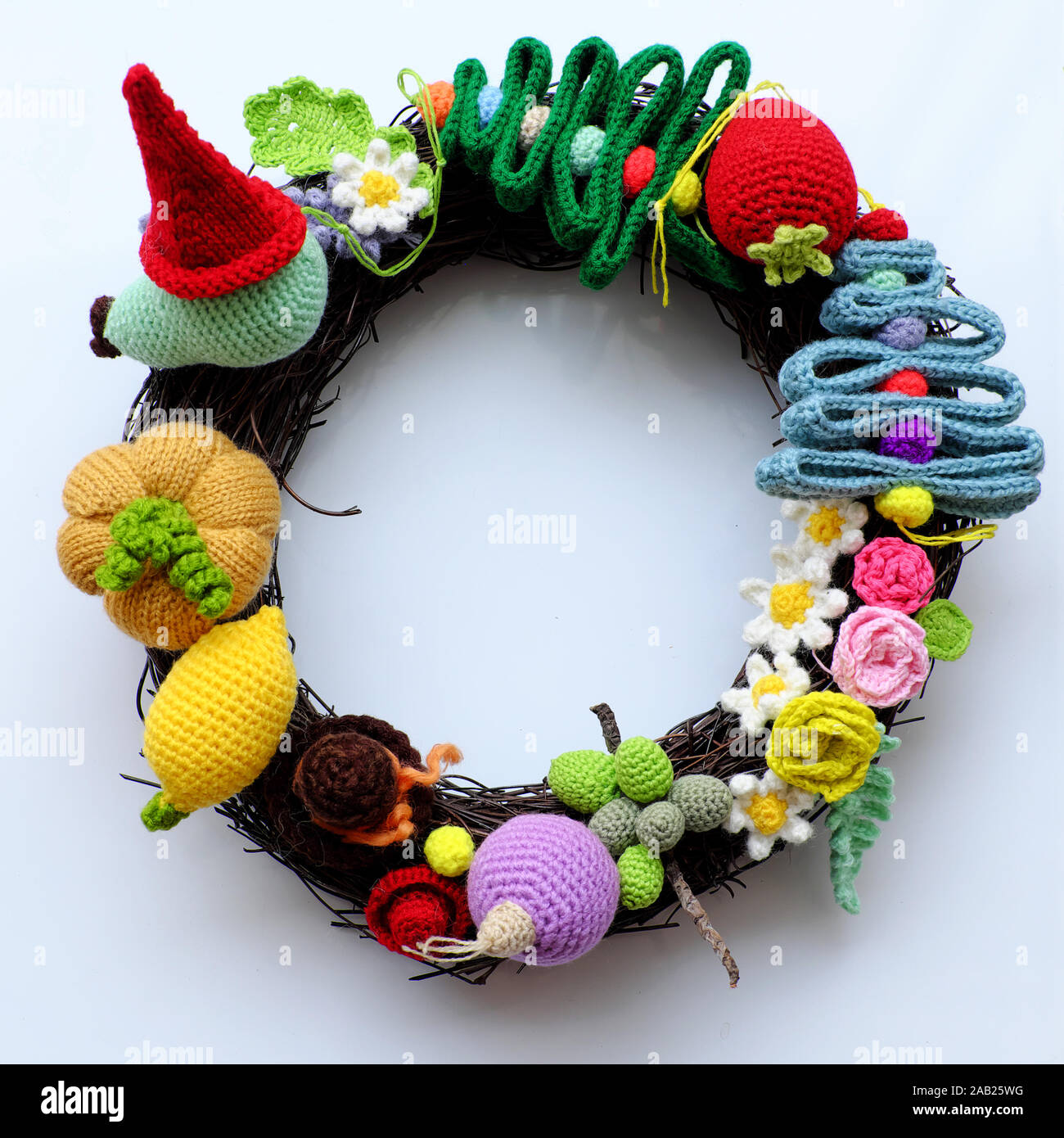 Amazing colorful Christmas wreath from handmade crochet product with multicolor yarn on white background, ornament  for garland from pine tree, flower Stock Photo