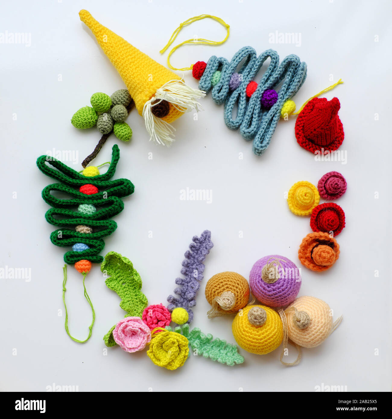 Christmas ornament for decoration winter holiday crochet from colorful yarn on white background, group of handmade product as leaf, fruit, pine tree Stock Photo