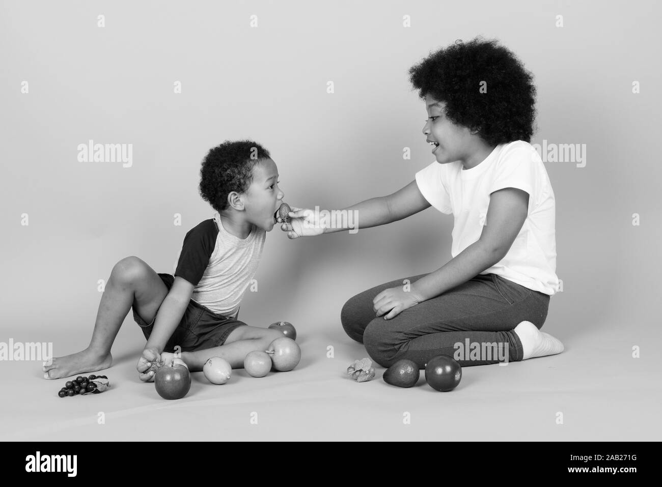 Young cute African siblings together in black and white Stock Photo