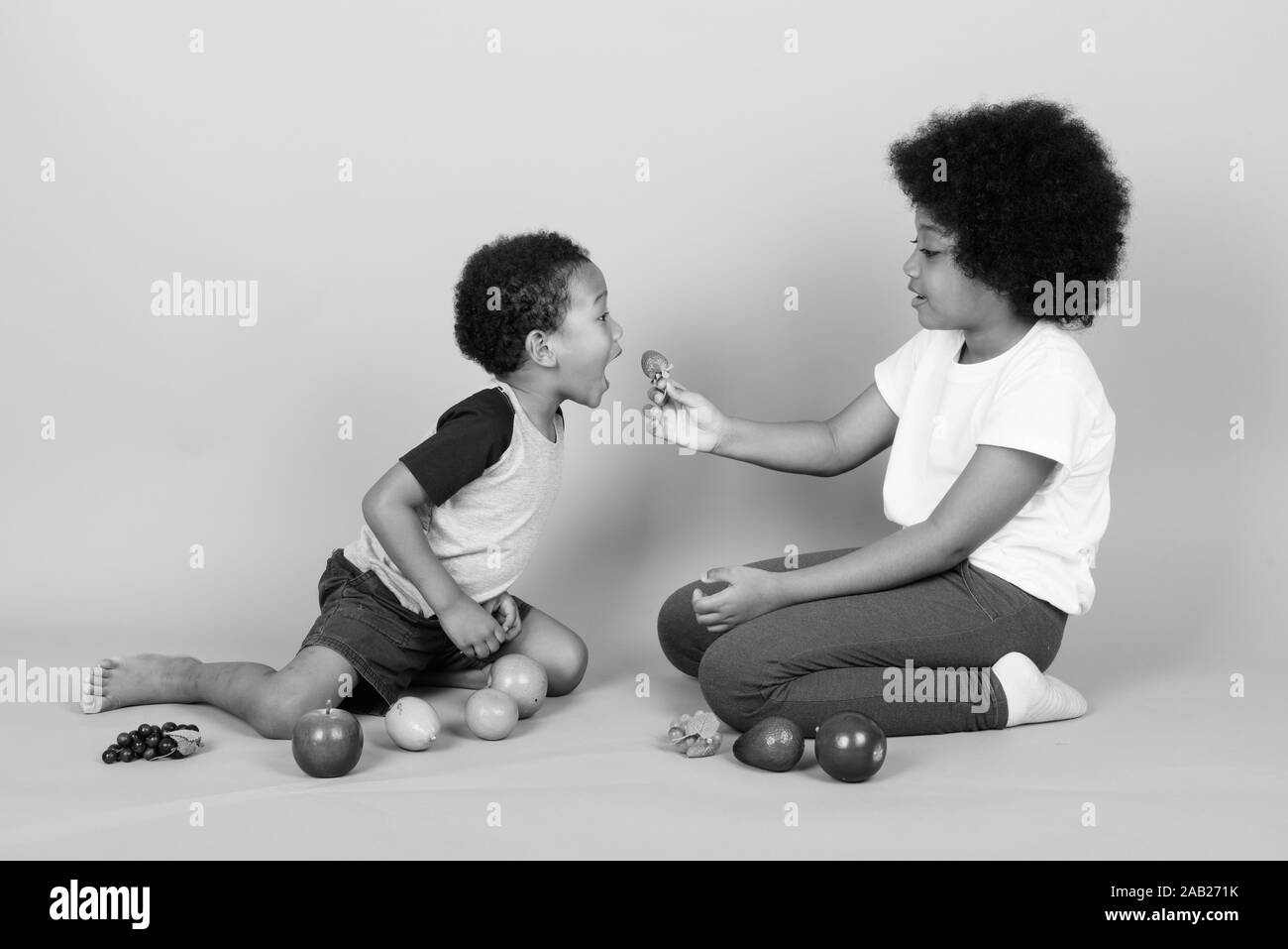 Young cute African siblings together in black and white Stock Photo