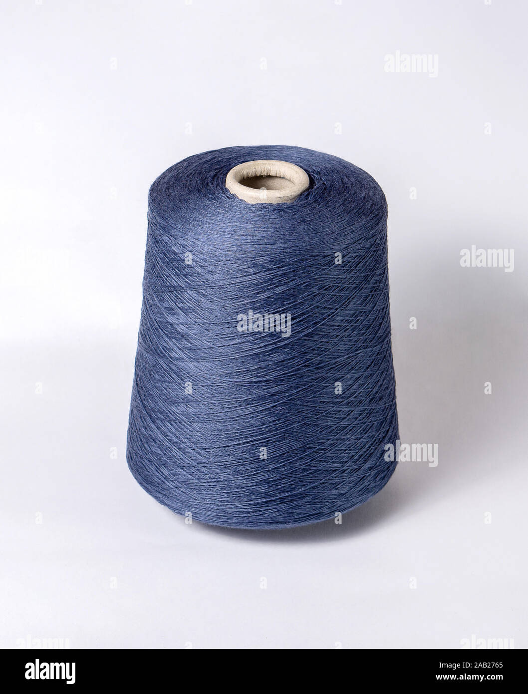 bobbin of yarn on a white background. Side view.Textile reel on