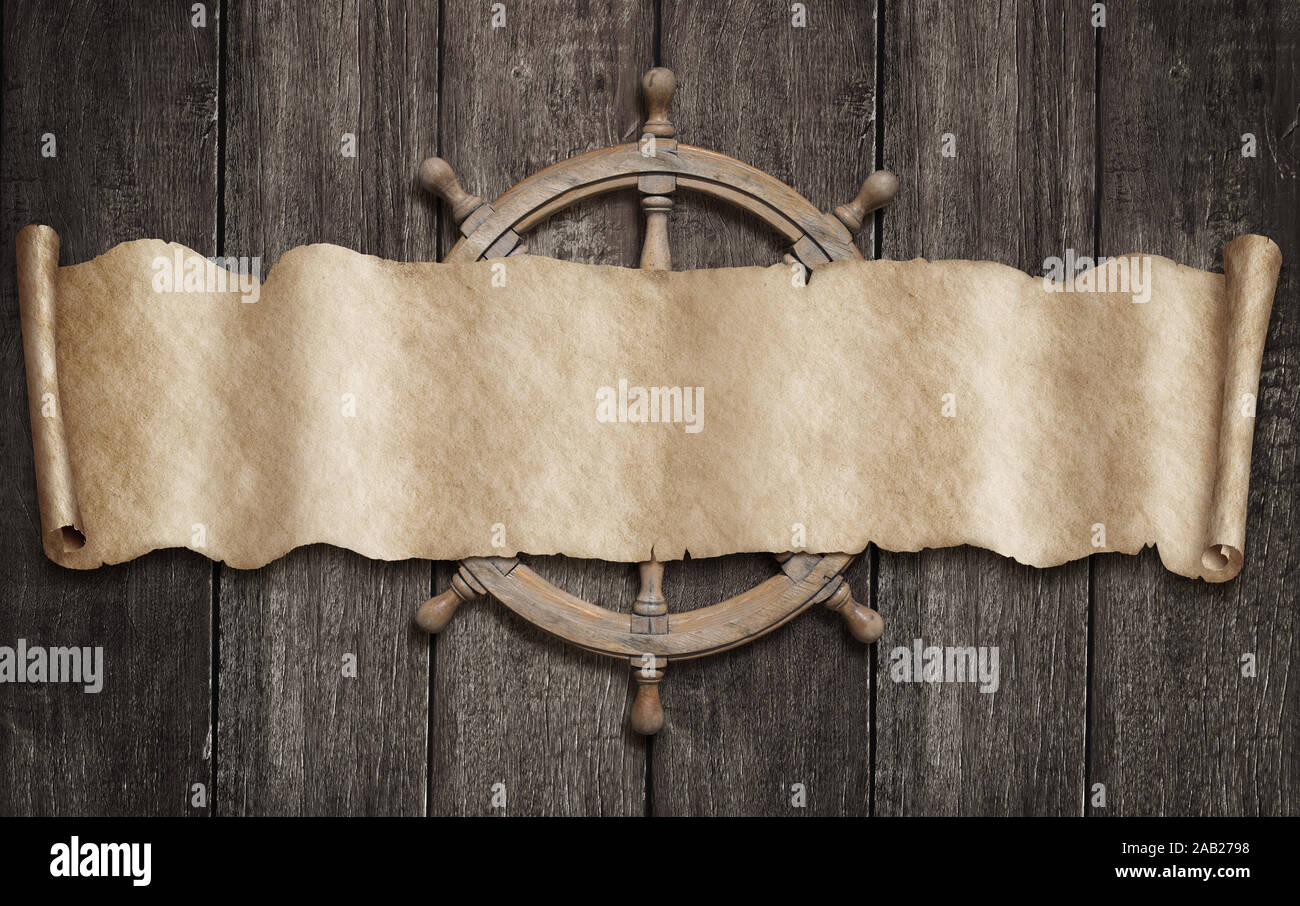 Old pirates map scroll and steering-wheel over wood background Stock Photo