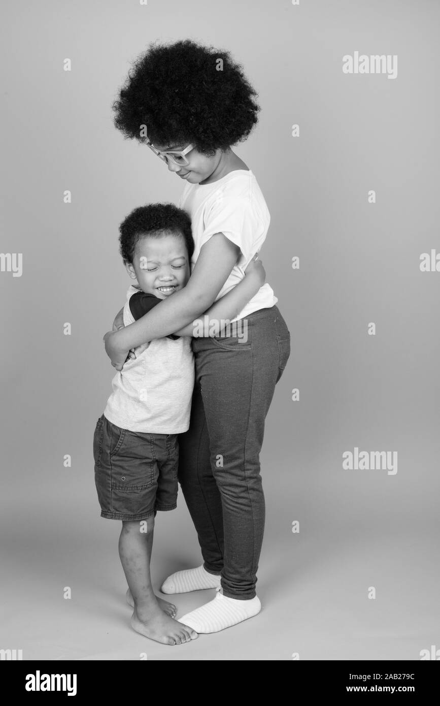 Young cute African siblings together in black and white Stock Photo