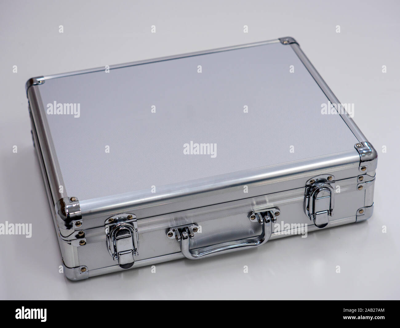 An aluminium metal briefcase isolated on a white office table. Business