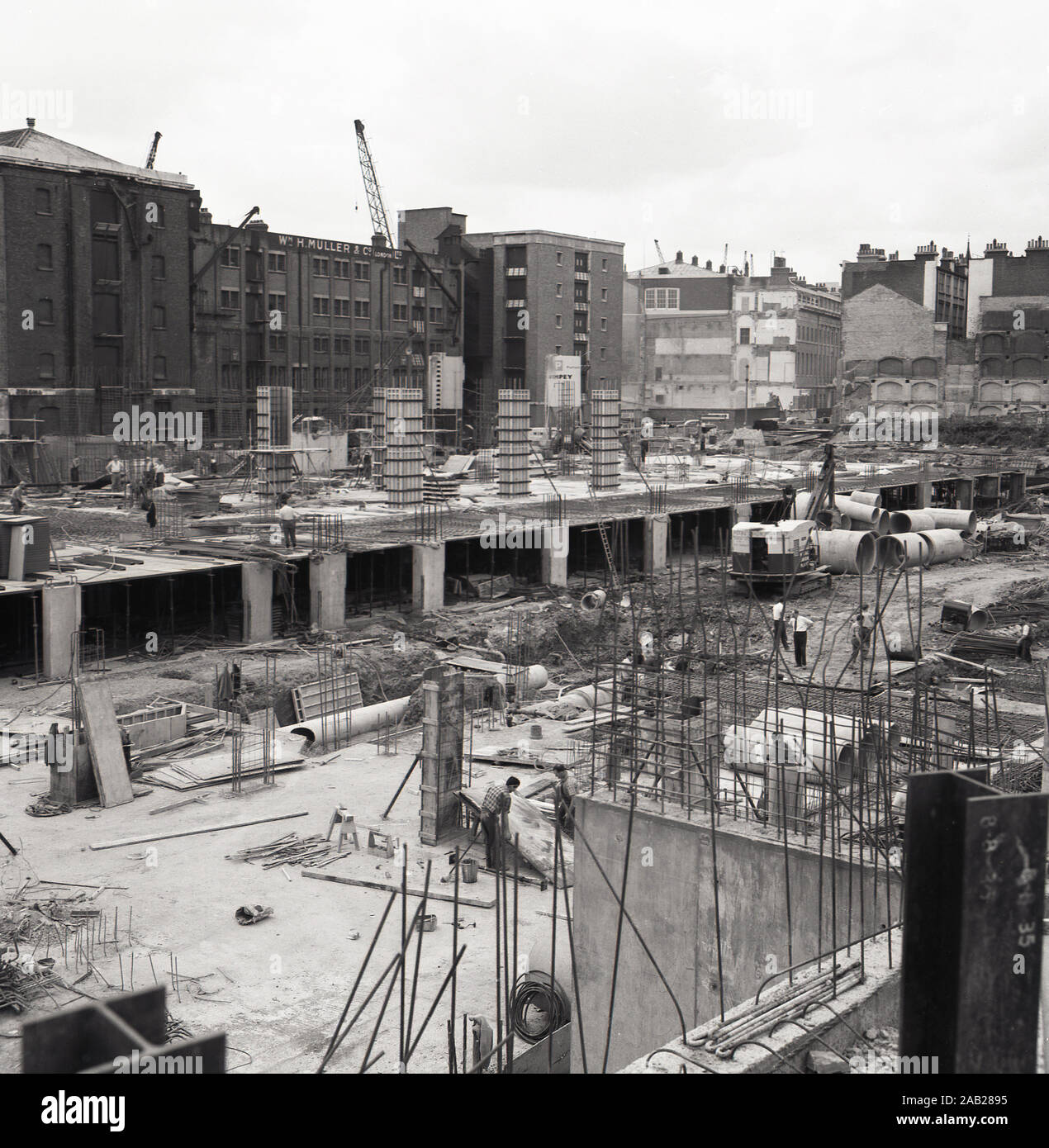 1960s, historical, construction site, city of London, England, UK, foundations for new 'modern' concrete office blocks being built. Note that none of the workmen on the giant site are wearing 'hardhats'. Stock Photo