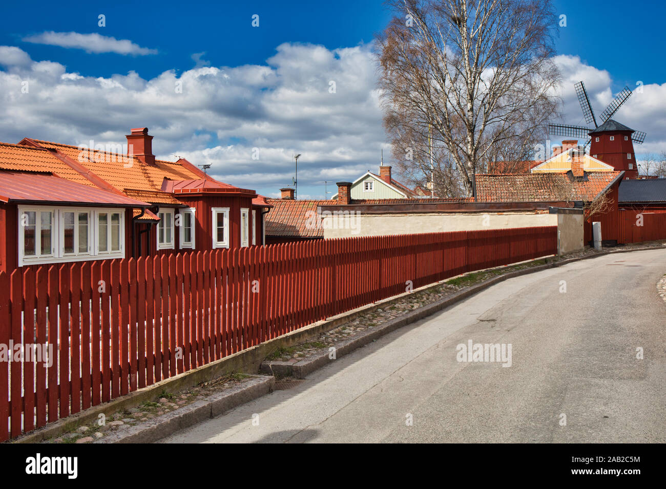 Falu red timber houses and windmill, Strangnas, Sodermanland County, Sweden Stock Photo