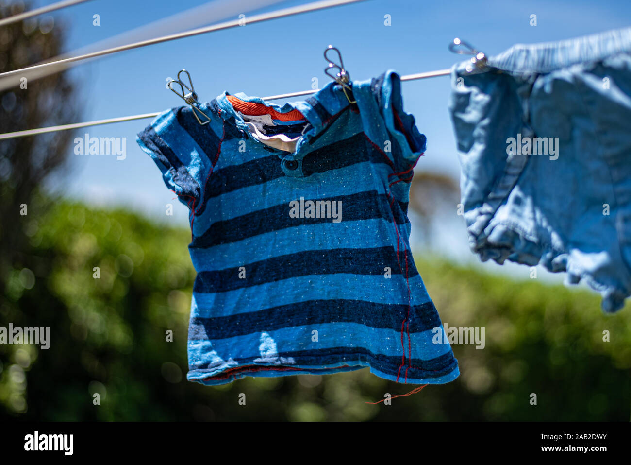 Reduce reuse recycle, be the change, metal long lasting clothes pegs, laundry drying in the sun, choose the earth, environmentally friendly. Stock Photo