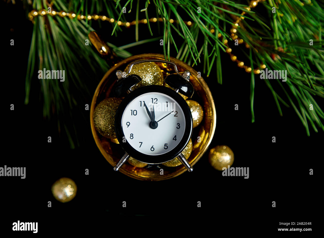 Black Alarm Clock And Fir Tree Branch Gold Christmas Decorations