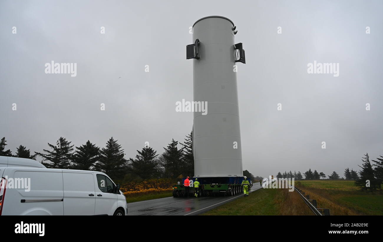 Hanstholm, Denmark, 25th November 2019: The 22-kilometer-long route from the port of Hanstholm to the installation site, the test center for windmills at Østerild, is closed by local police to ensure a clear and safe route for the 28-meter-high and 8-meter-wide windmill section that is being moved in upright position. Using SPMTs for the transport ensures the stability, integrity and safety of the upright load over uneven roads and inclinations. Credit: Brian Bjeldbak/Alamy Live News Stock Photo