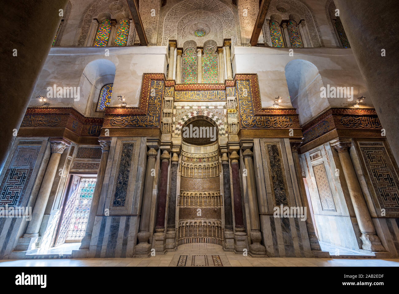 Mausoleum of Sultan Qalawun with decorated colorful marble niche - Mihrab - embedded in decorated marble wall, and colorful stain glass windows, Moez Street, Gamalia District, Medieval Cairo, Egypt Stock Photo