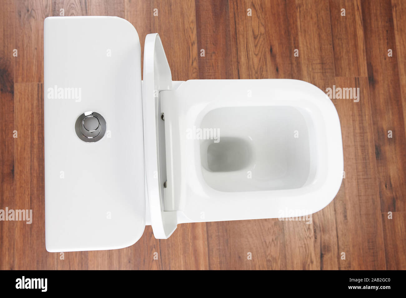 White open toilet above top view on wooden floor background Stock Photo -  Alamy