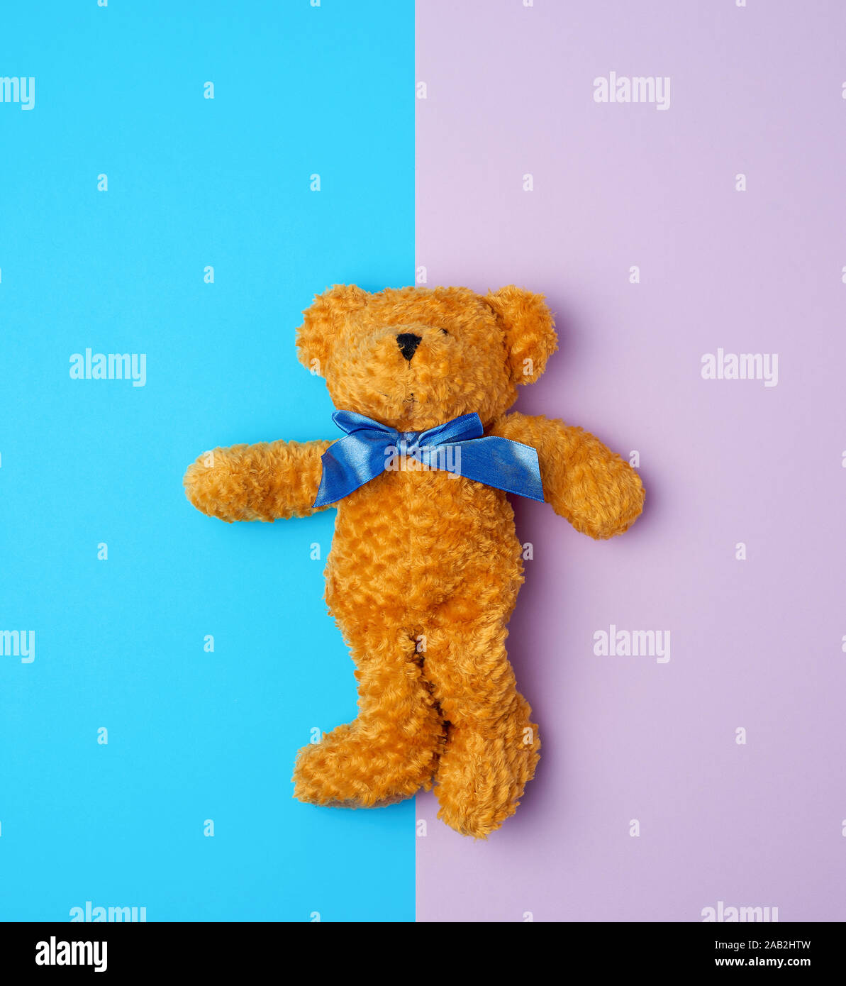 cute brown teddy bear with a blue bow on his neck, blue purple ...
