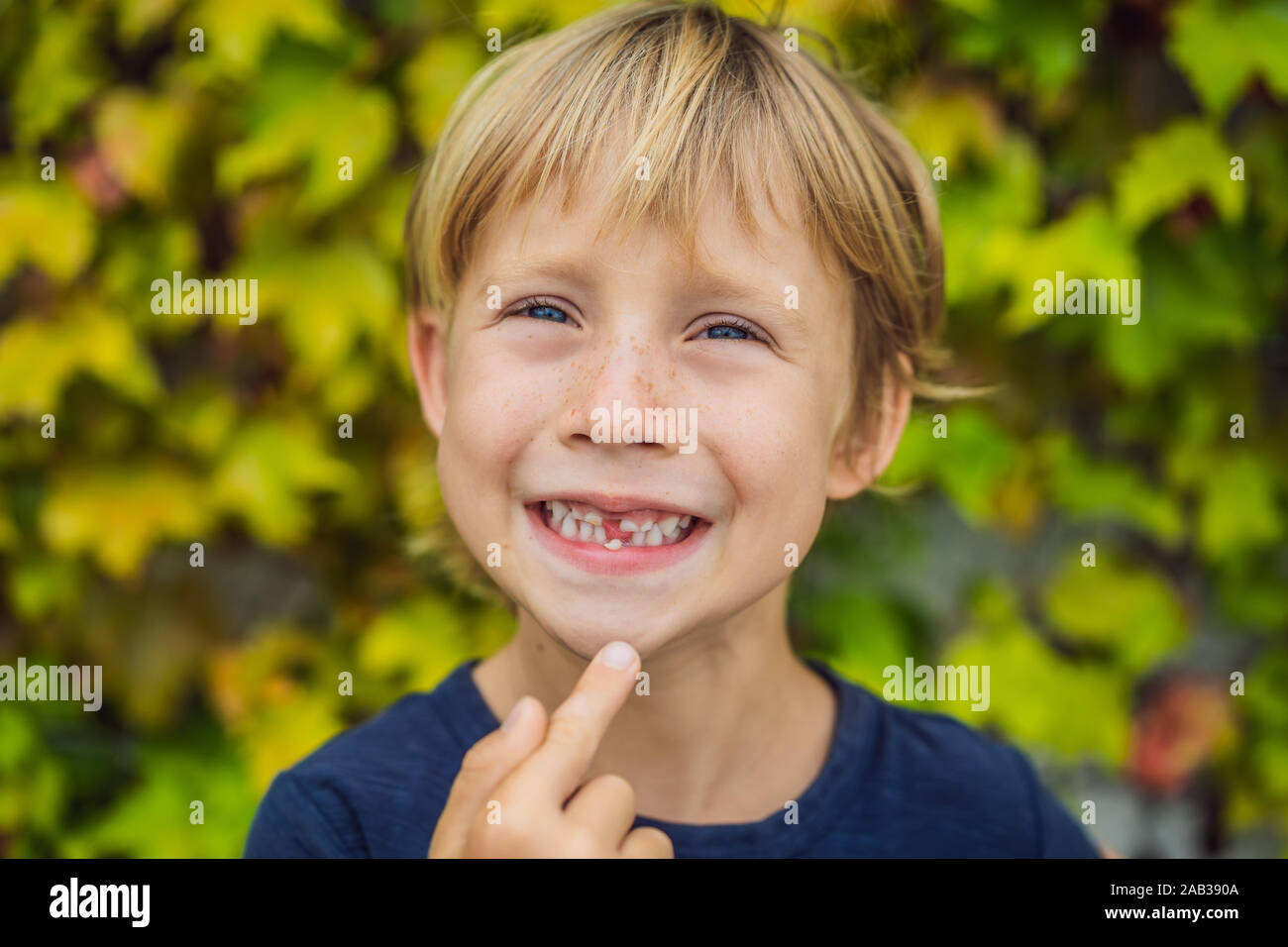 Little smiling child boy hand pointing his first baby milk or temporary