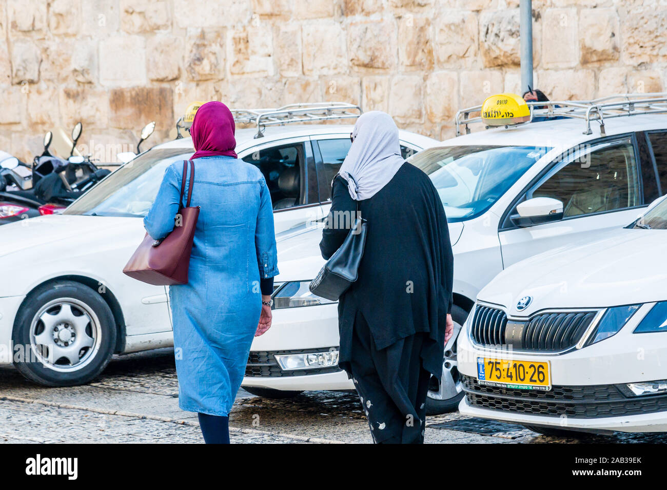 JERUSALEM, ISRAEL / 25 NOV 2019: Two Muslim women wearing hijbas (head coverings mandated by Islamic law), Jerusalem’s Old City Stock Photo