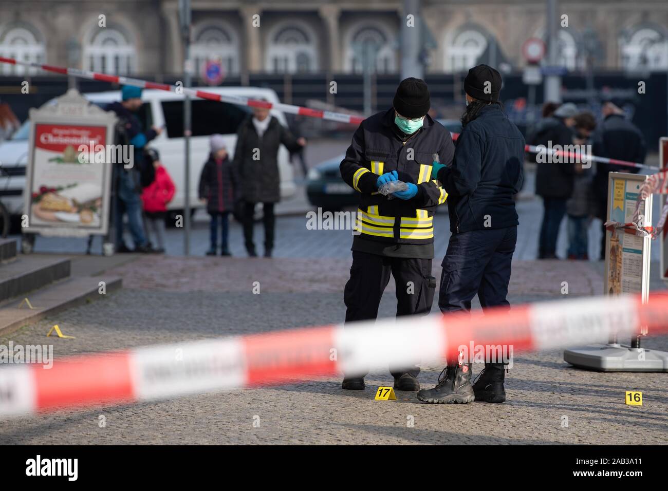 Dresden, Germany. 25th Nov, 2019. Policemen are standing behind a barrier tape in front of the Schinkelwache building. Dresden's Treasury Green Vault was broken into early in the morning. The break-in affects the historical part of the valuable collection. Credit: Sebastian Kahnert/dpa-Zentralbild/dpa/Alamy Live News Stock Photo