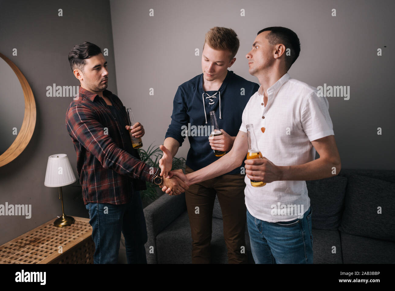 Friends make bets. Young man breaks friends handshake Stock Photo Alamy