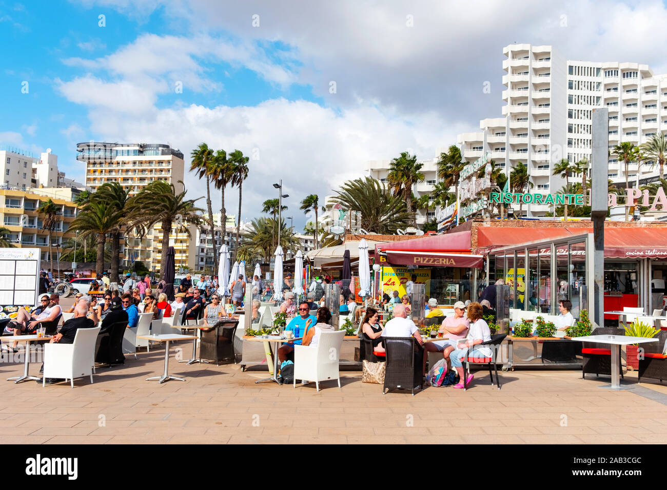 MASPALOMAS, SPAIN - JANUARY 21, 2019: Vacationers at the restaurant terraces of Playa del Ingles, in Maspalomas, in the Canary Islands, Spain, a popul Stock Photo
