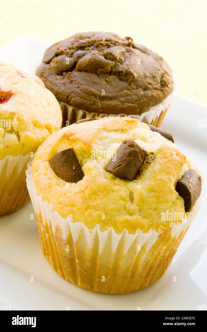 Homemade jumbo sized breakfast muffins. Included in the assortment are chocolate chip and chocolate marshmallow and buttermilk strawberry items. Stock Photo