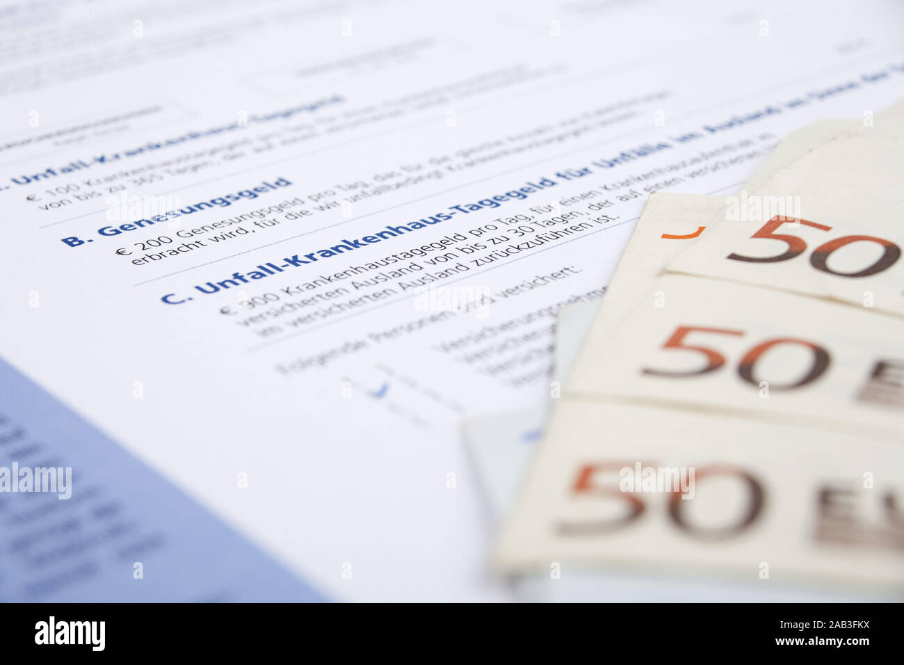 Versicherungsschein einer Unfallversicherung mit Geldscheinen |Insurance policy of accident insurance with bank notes| Stock Photo