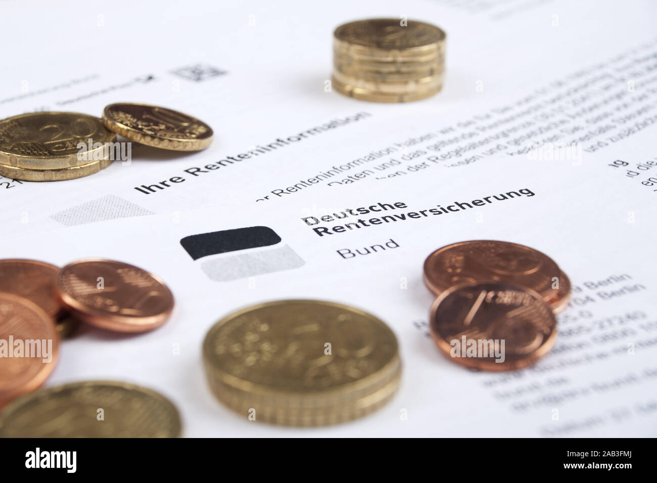 Euromuenzen mit einem Informationsblatt der Rentenversicherung  |Euro coins with an information sheet of the pension insurance| Stock Photo