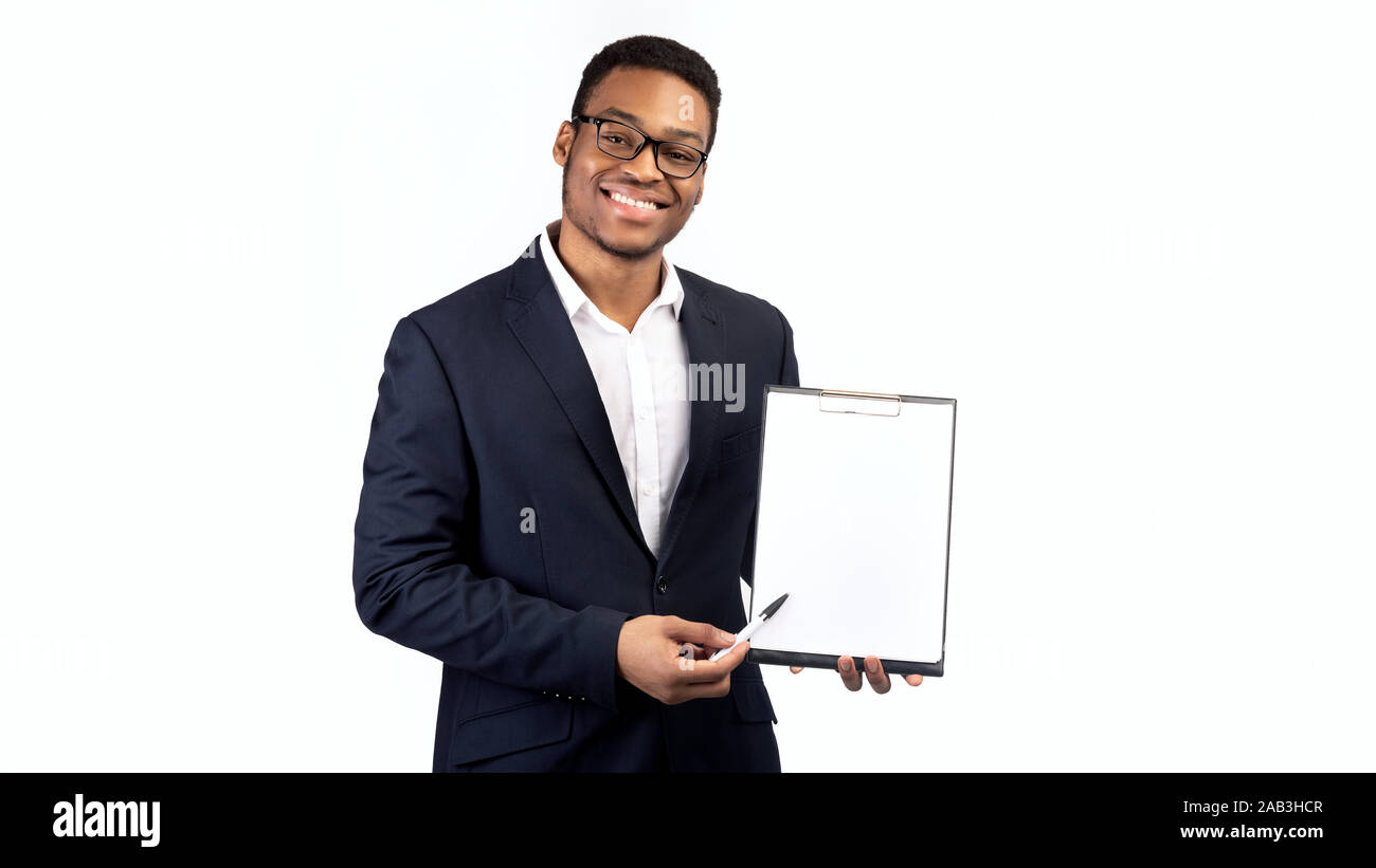 Black guy in suit showing blank clipboard Stock Photo