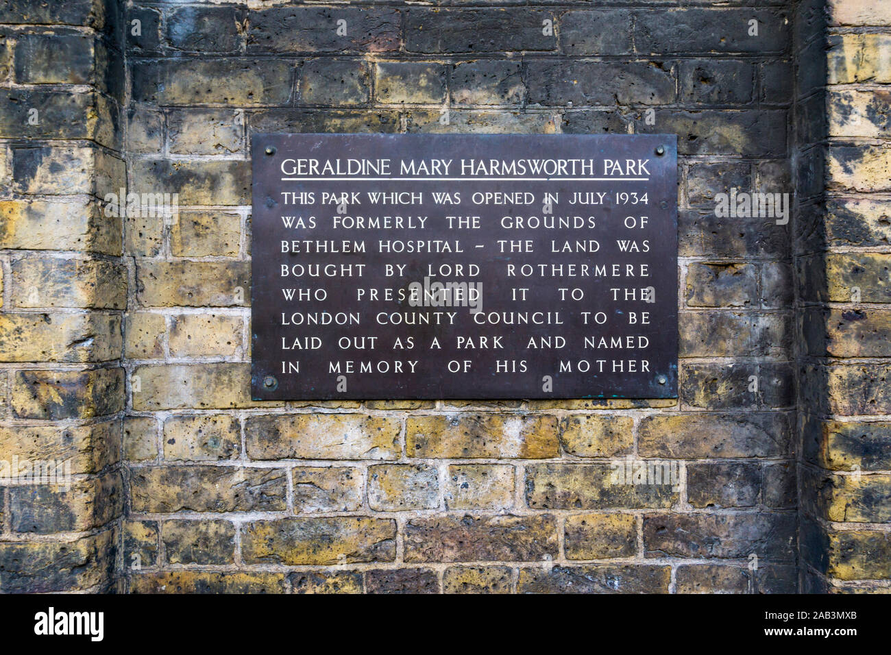 A plaque in Geraldine Mary Harmsworth Park in Southwark records that it was previously the grounds of Bethlem Hospital - the origin of the word Bedlam Stock Photo