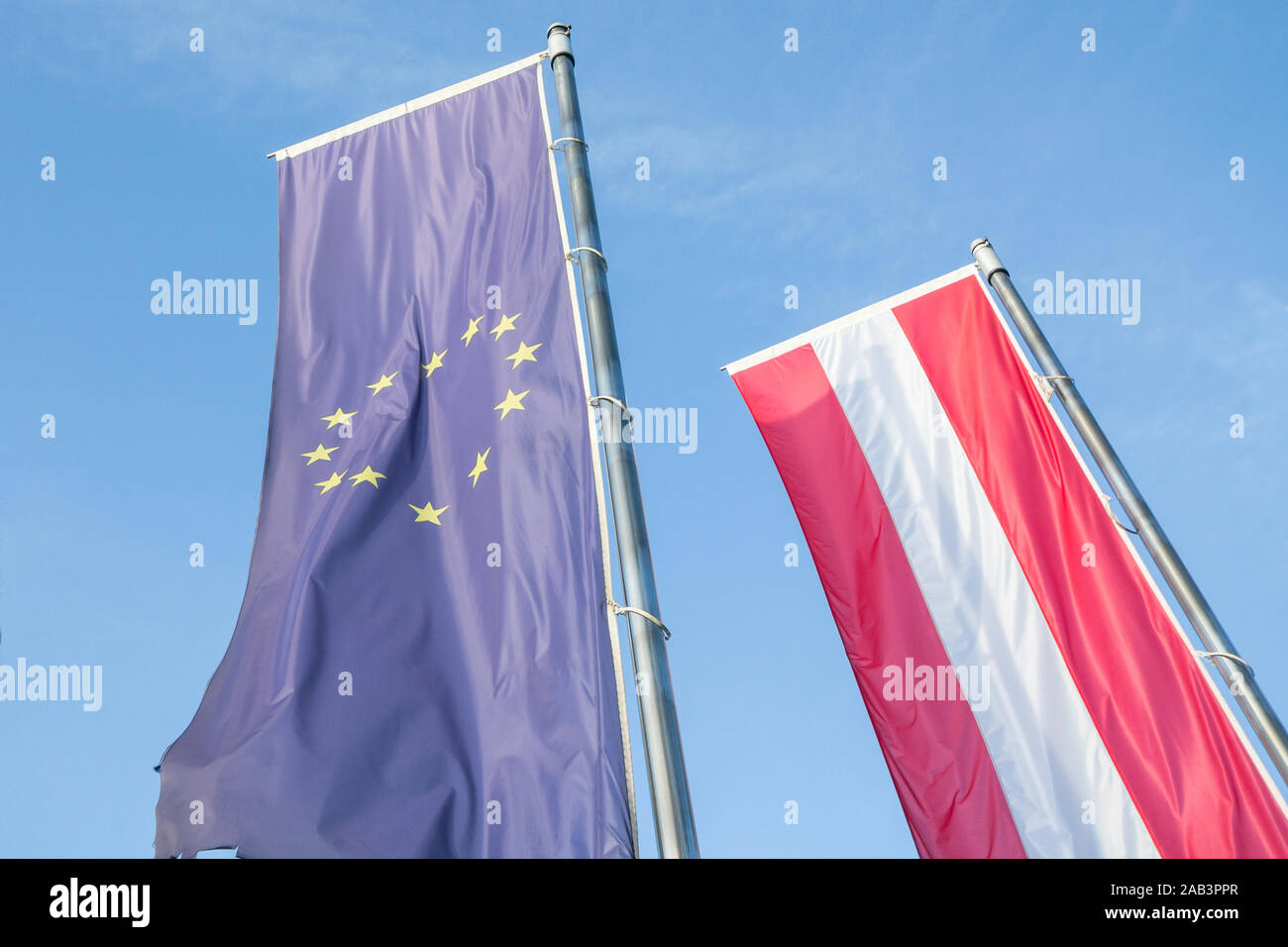 Flags of the European Union and Austria waiving together in the Austrian capital city, Vienna. Austria is a member of the EU since 1995 and a major ac Stock Photo
