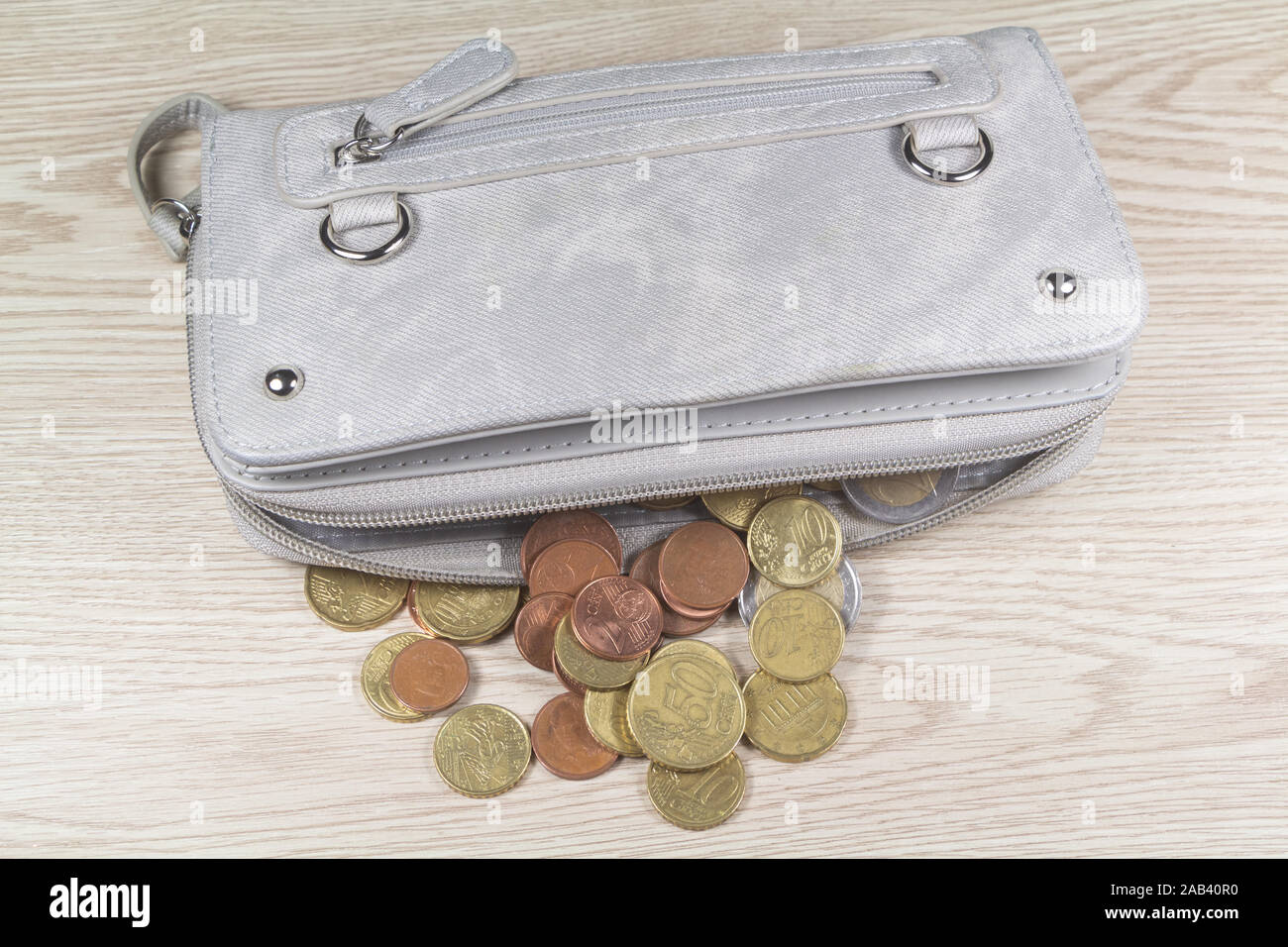 Euros coins take out of a purse on wooden background Stock Photo