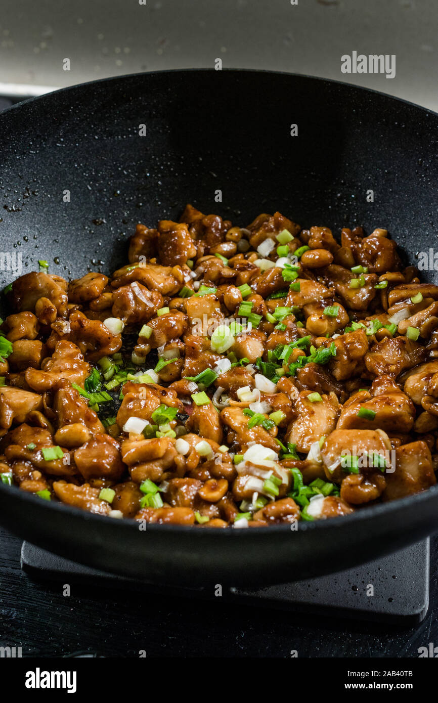 Homemade Kung Pao Chicken with Peanuts, Peppers, Soy Sauce, Green Chives  and Veggies in Wok Pan. Traditional Food Stock Photo - Alamy