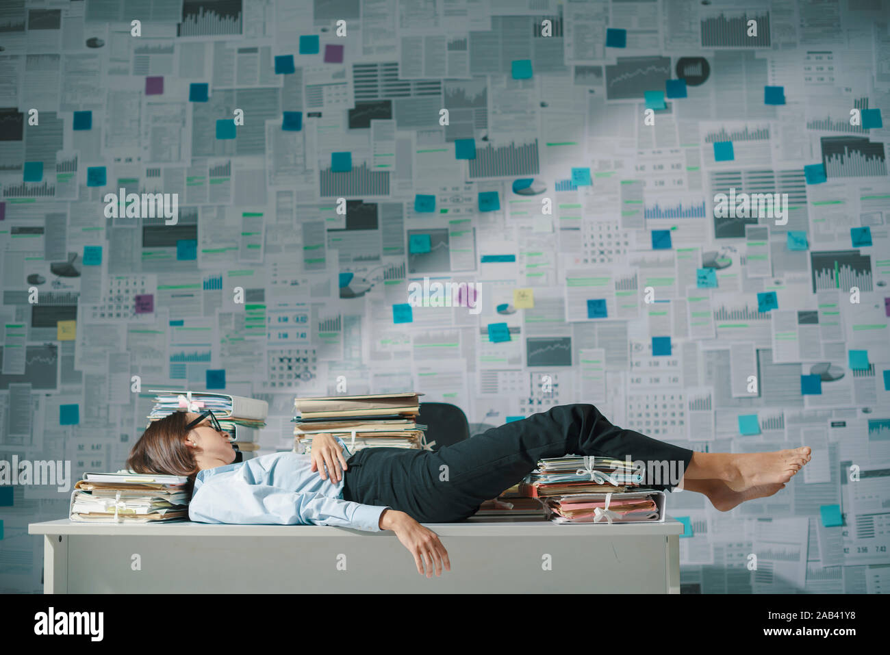 Exhausted Business Executive Lying Down On The Desk And Sleeping
