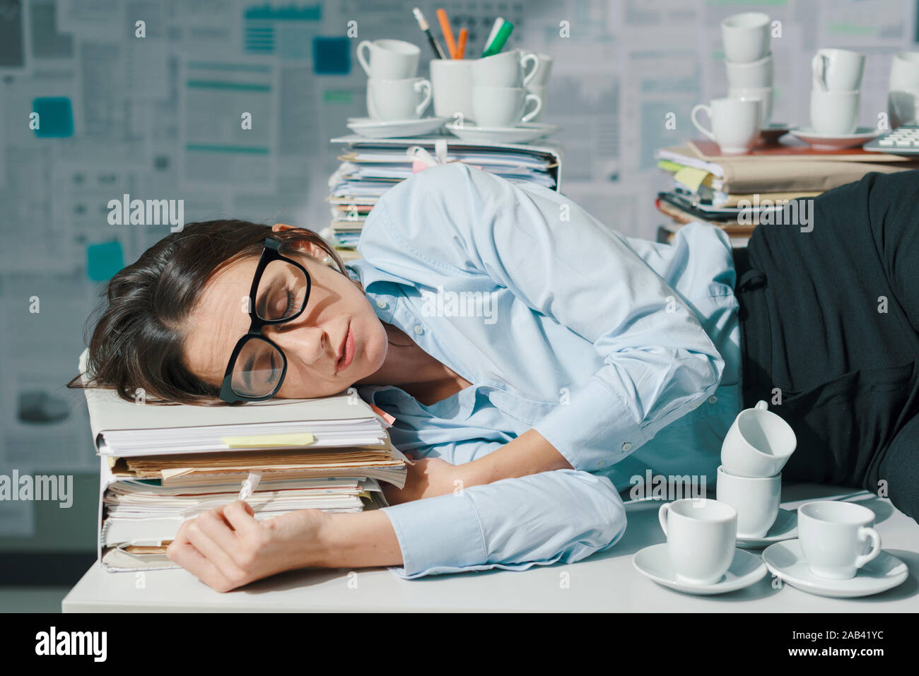 Exhausted Overworked Businesswoman Lying Down On The Office Desk