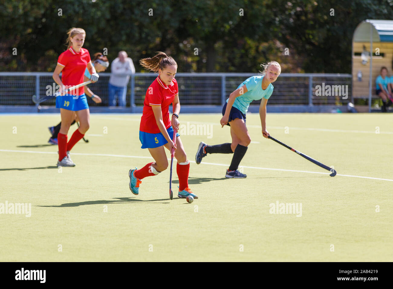 Field hockey female players run with ball in attack Stock Photo Alamy