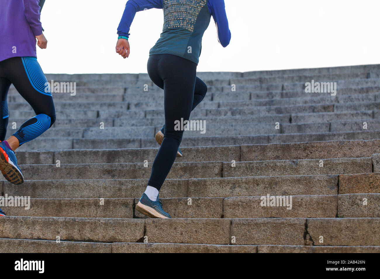 Man and woman run on the stairs in the morning Stock Photo