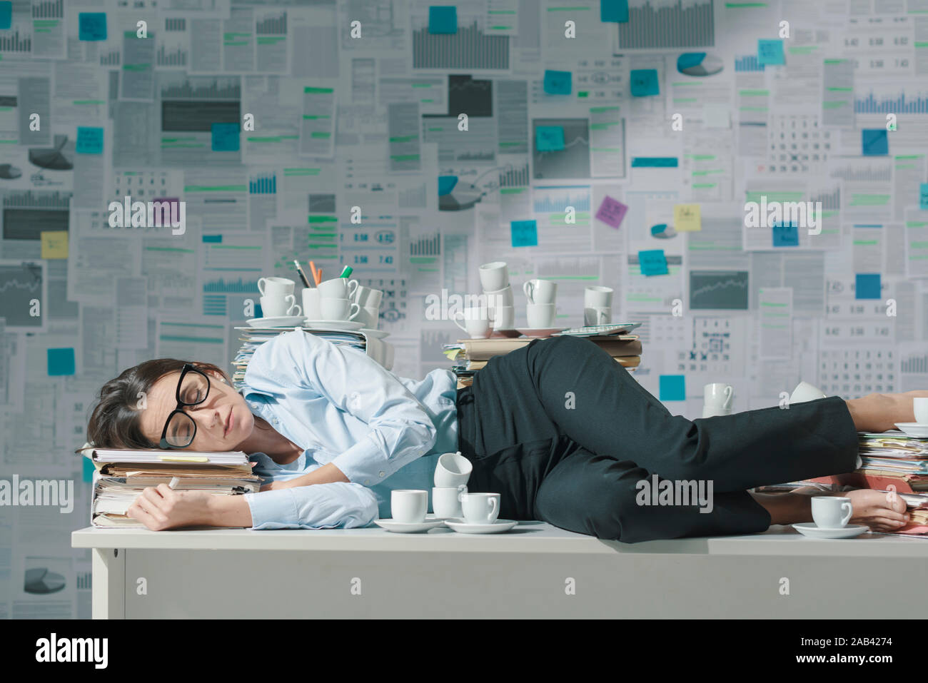 Exhausted Overworked Businesswoman Lying Down On The Office Desk
