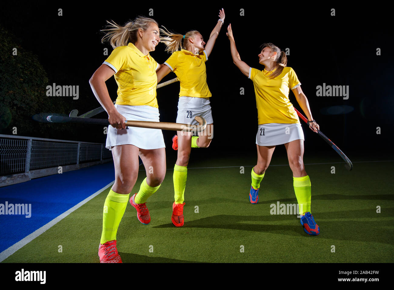 Group of female field hockey players celebrate the victory Stock Photo